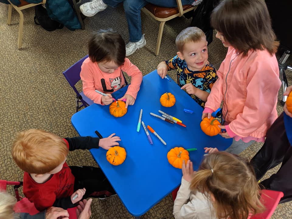Kids coloring pumpkins at Varina Library